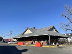 The former PRR Freehold RR Station, now a NJT bus terminal, with the TFT train on the left